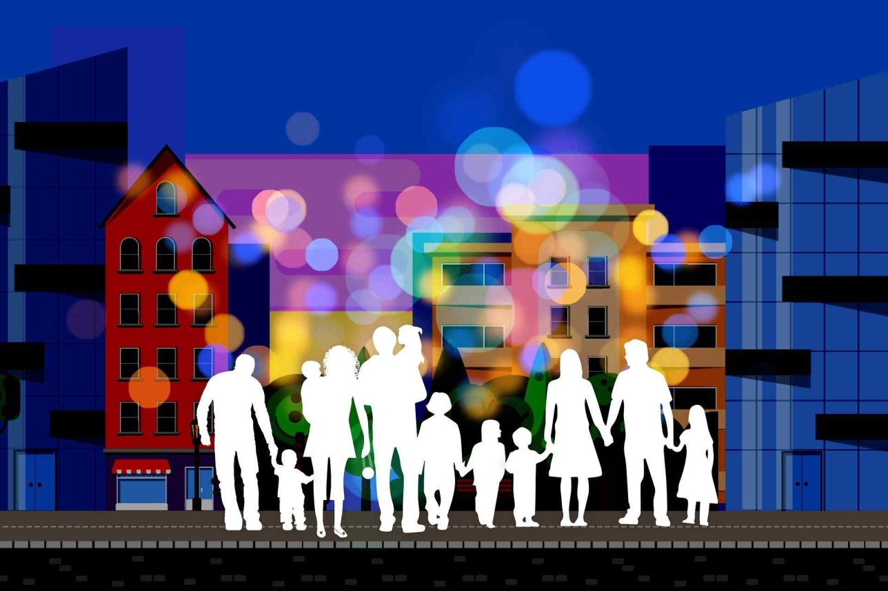 Silhouette of group of people in front of houses