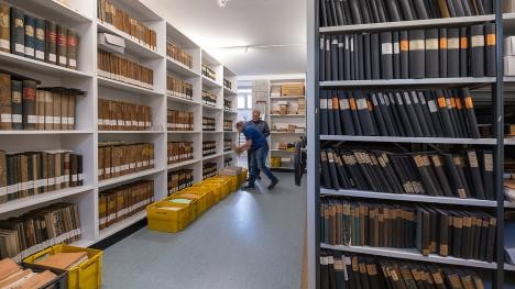 Aisles with files in the city archive Rastatt and employees