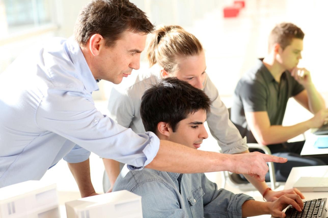 Trainees with trainers at the workplace