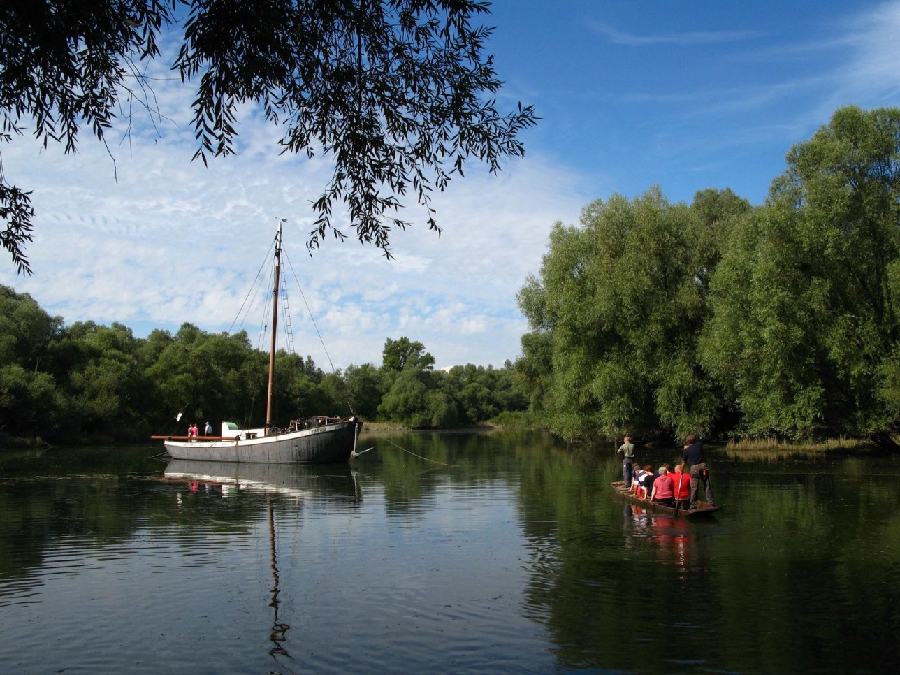 A group of visitors boarded the Aalschokker in a boat. 