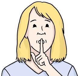 Eine Frau hält den Zeigefinger vor dem Mund