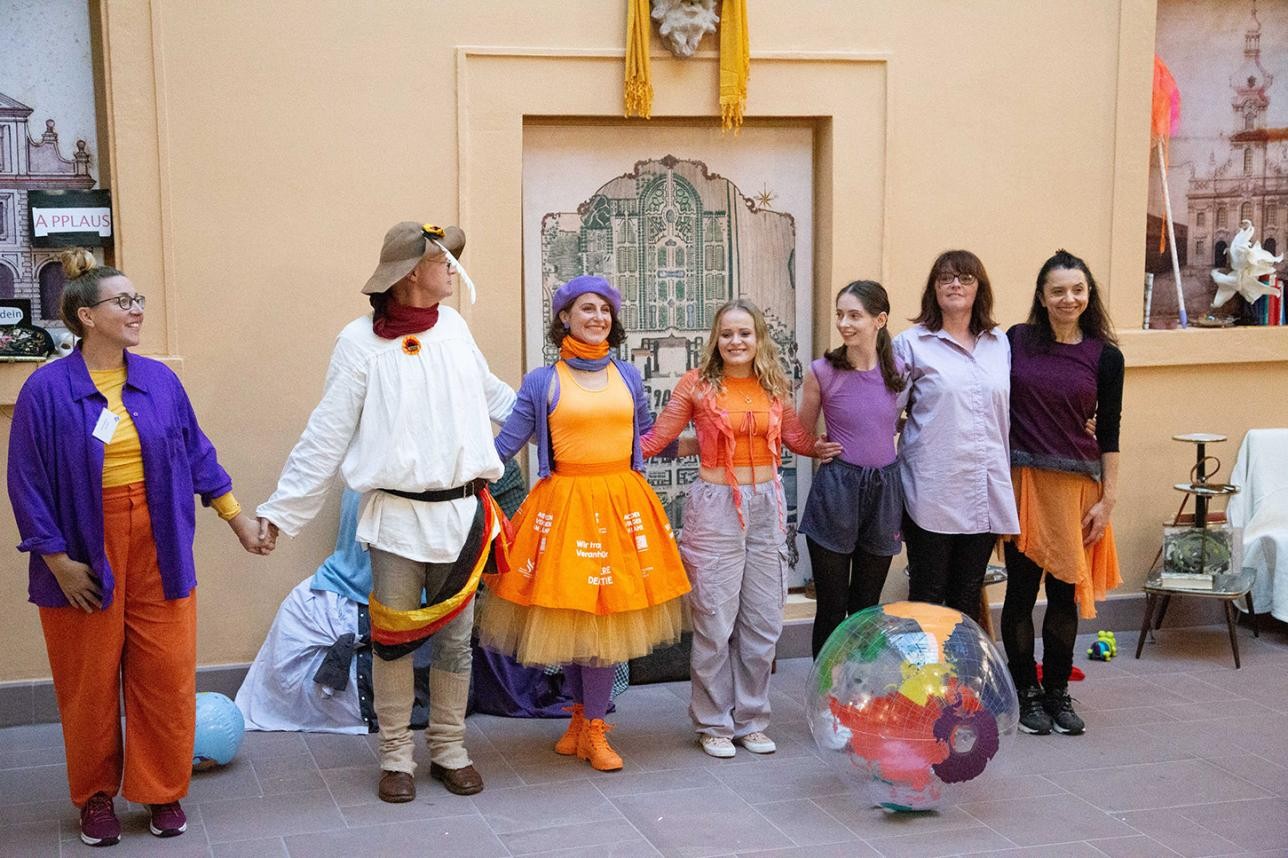 Un groupe de danseurs s'incline sur scène